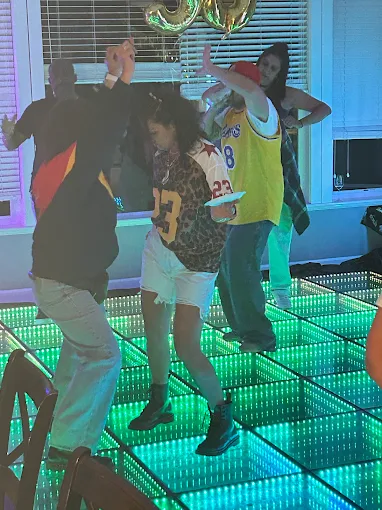 Guests dancing on a green illuminated LED floor